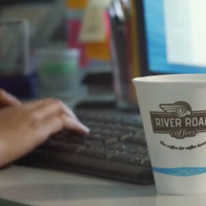 Office Coffee Cup with productive person working
